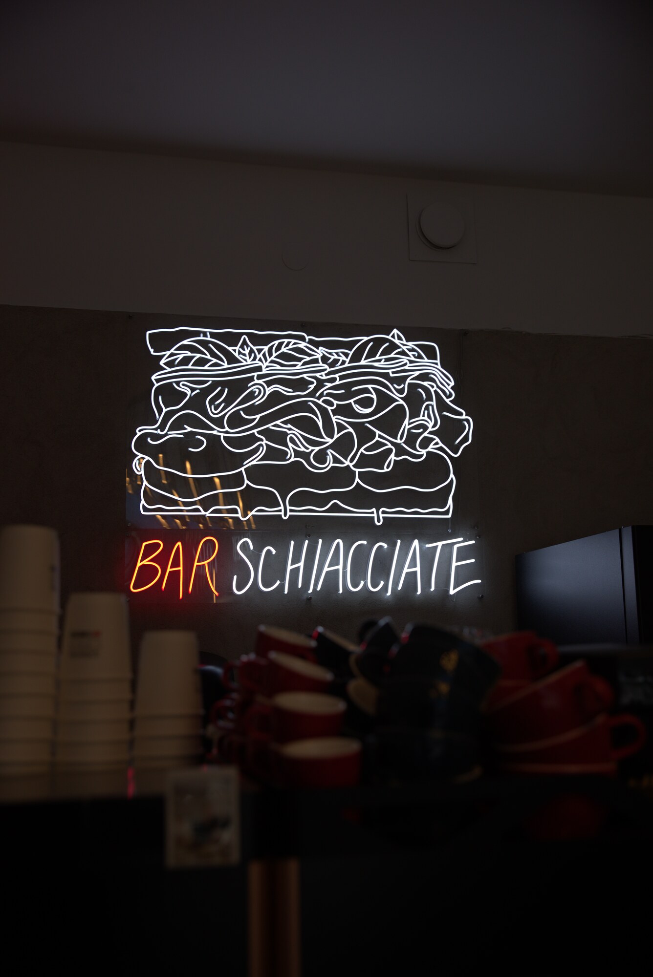 Upplyst neonlogotyp med schiacciata-brödet